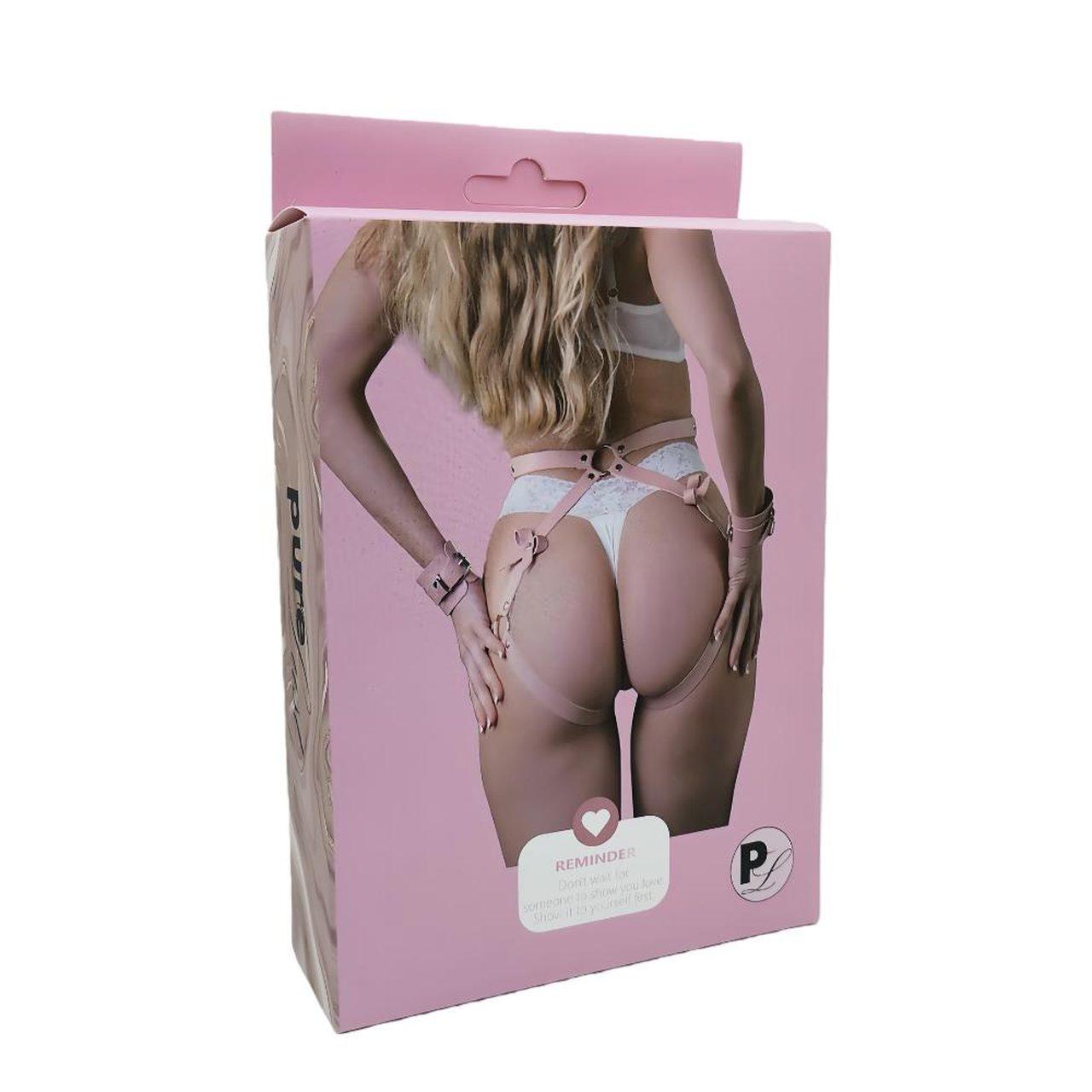 Różowa uprząż BDSM z opaskami na nadgarstki i kółkami | Loris.pl